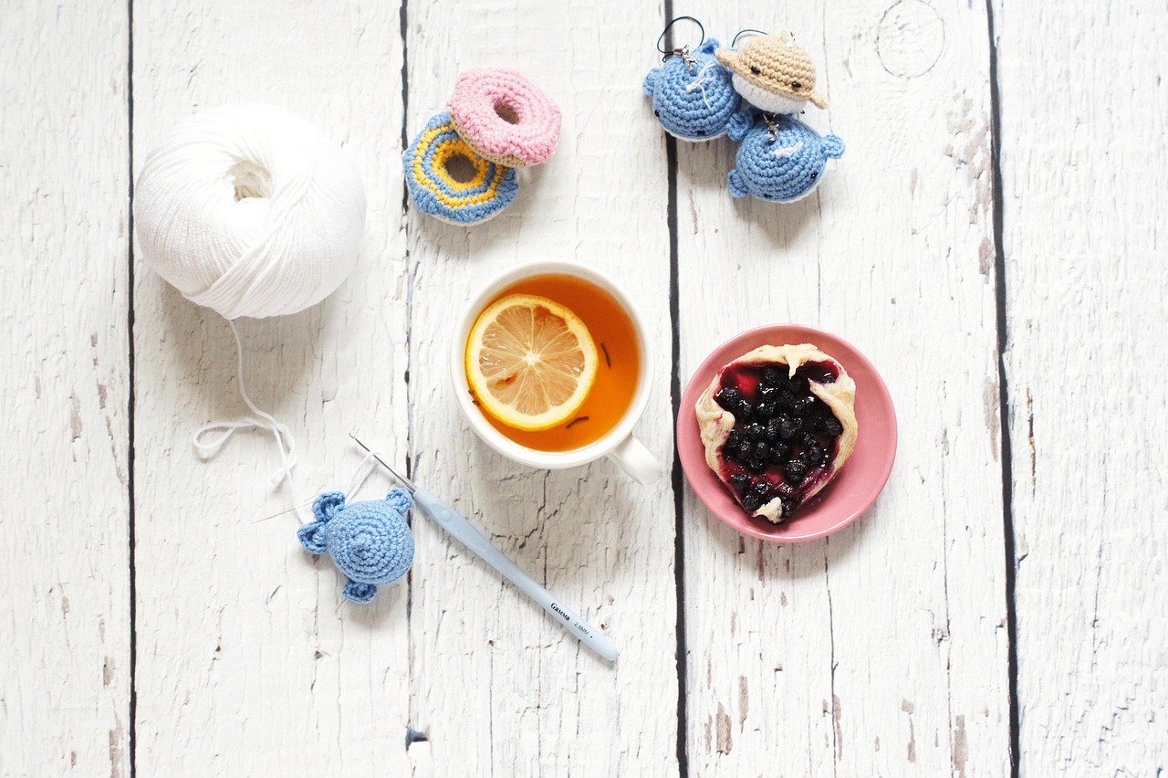Cozy crochet workspace with tea, yarn and handmade amigurumi - mindful crafting setup