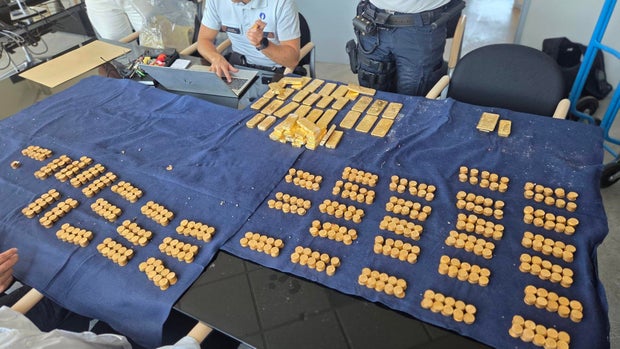 Belgian police inventory of gold bars and coins on official table