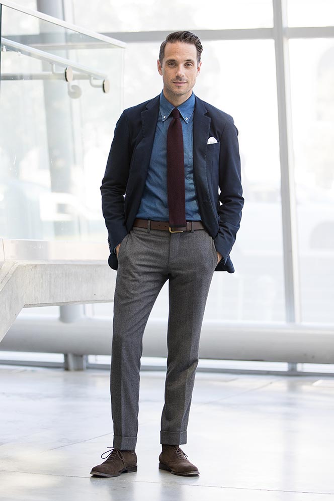 Man in navy blazer with blue dress shirt and burgundy solid tie demonstrating business casual with tie styling