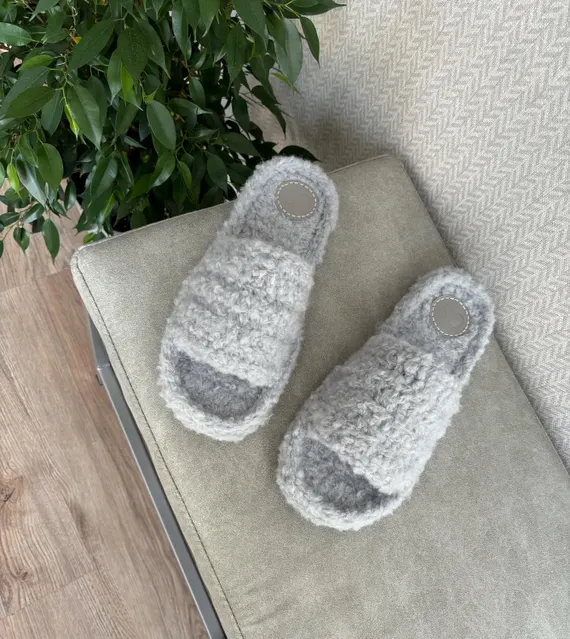 alt="Fluffy handmade grey knitted wool slippers on soft soles — comfortable felted house shoes"