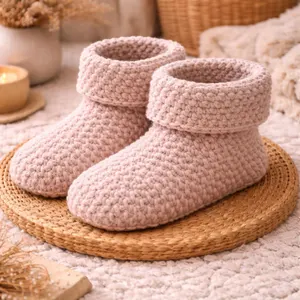 Chunky beige crochet house booties on woven mat — soft handmade home slippers with cozy texture