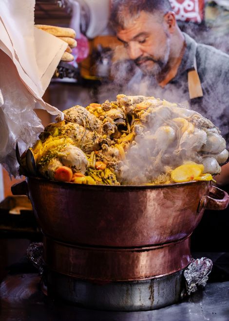 Steaming copper pot of traditional Fes street food
