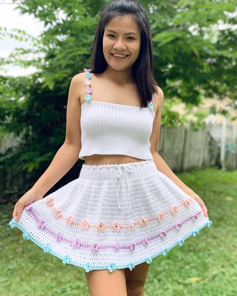 White crochet crop top and skirt set with pastel lavender and pink accents, handmade summer