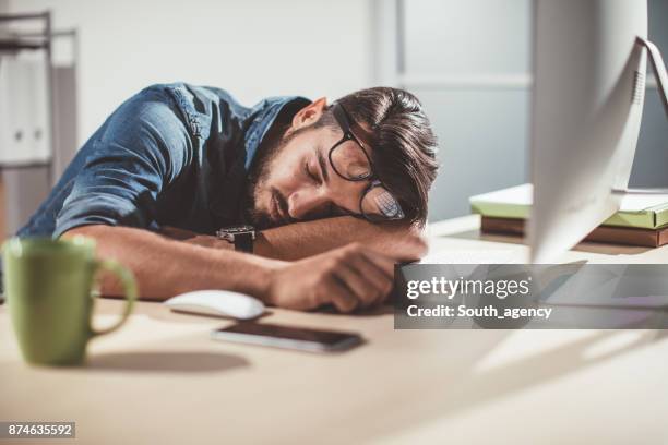 Exhausted man asleep at desk