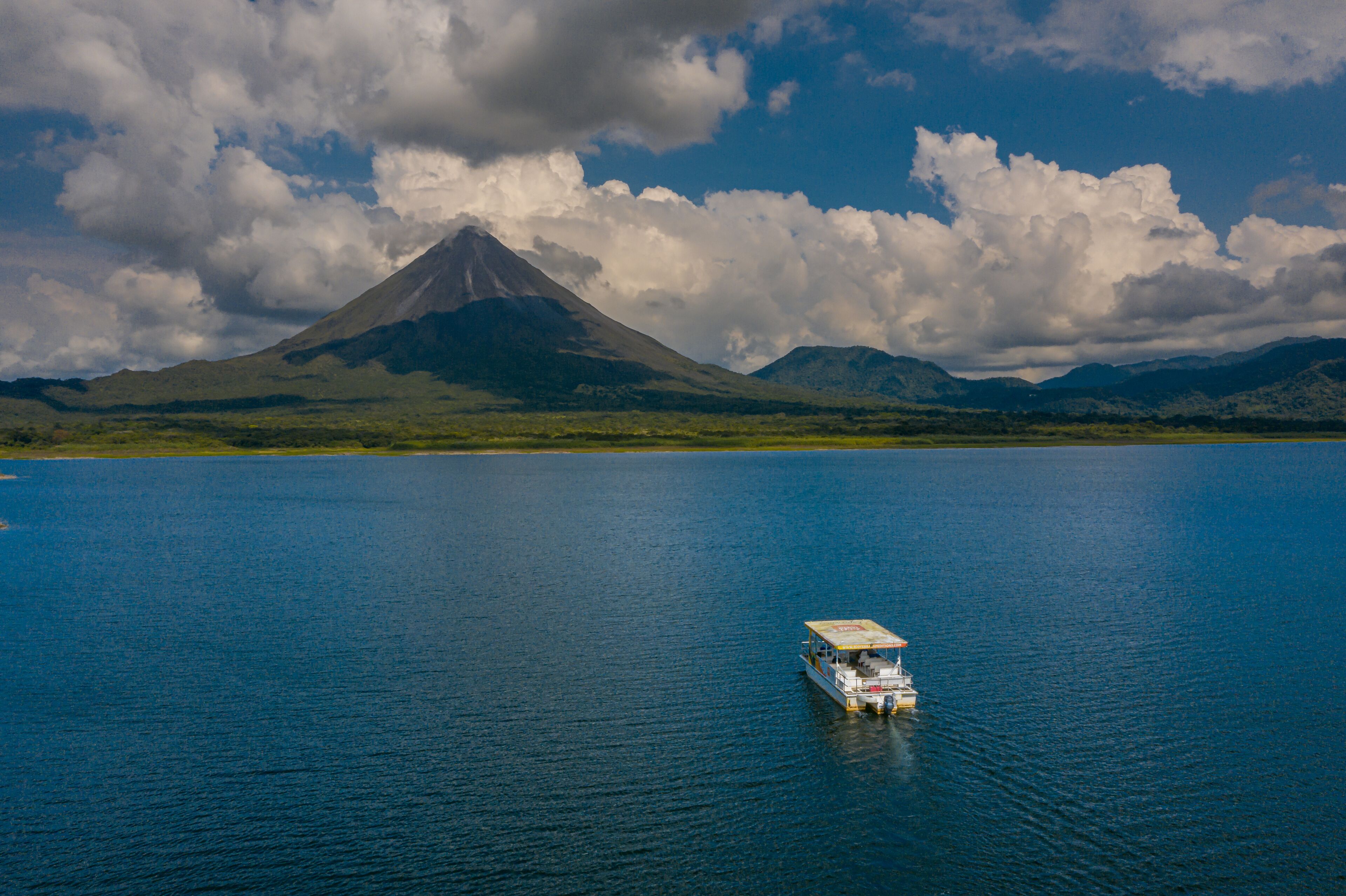 Aerial view of Lake Arenal with boat and Arenal Volcano