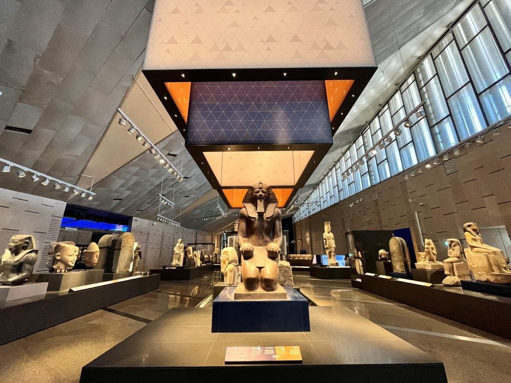 Grand Egyptian Museum interior hall with statues