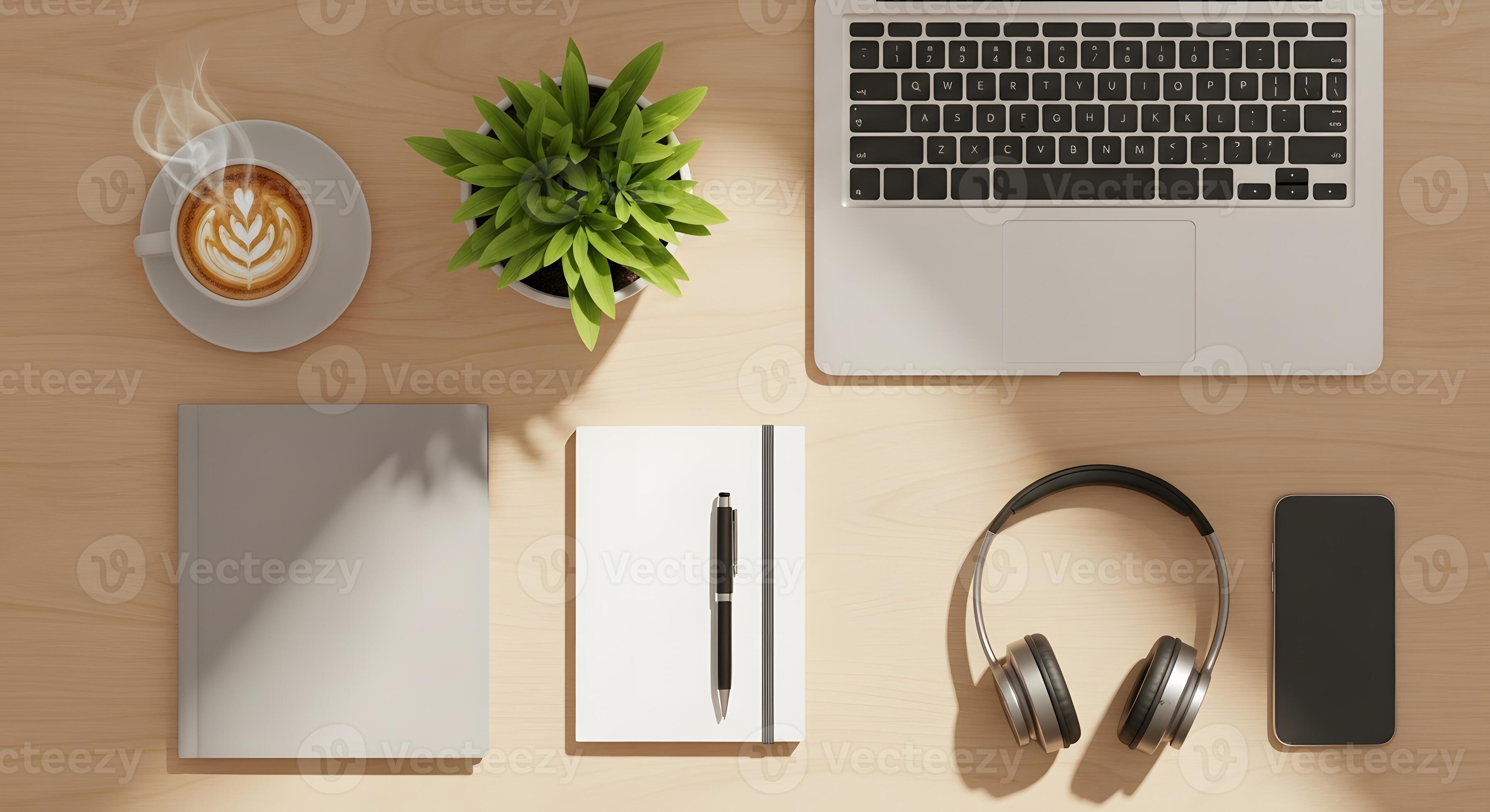 Mesa de trabalho organizada com laptop, café e fones de ouvido