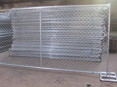 Galvanized chain link temporary fence panels on a construction site
