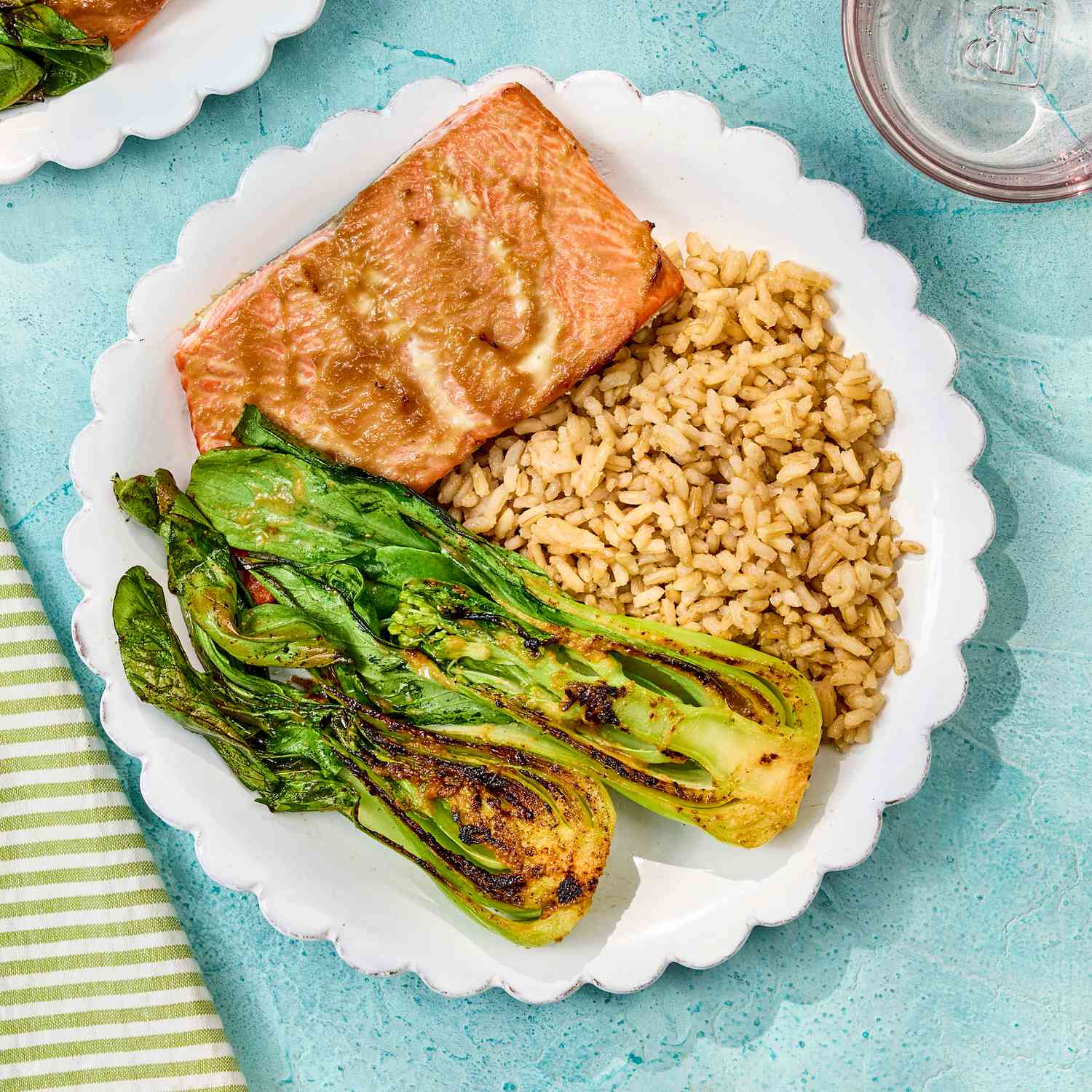 Simple healthy dinner plate with glazed salmon brown rice and grilled bok choy