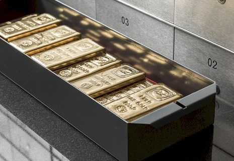 Secure precious metals vault with organized gold and silver bullion