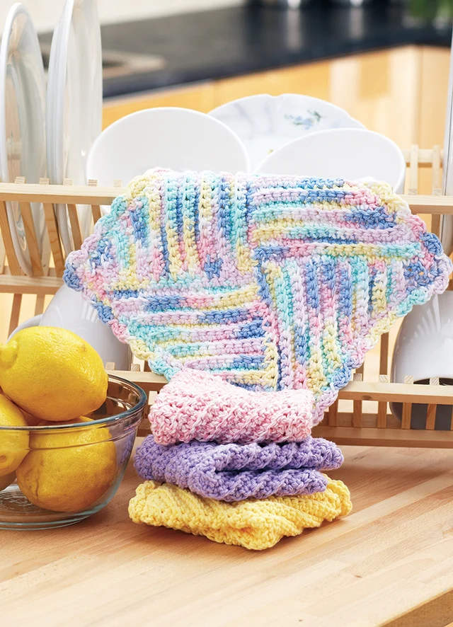 White crochet hand towel with diagonal red, teal and navy blue stripes — colorful cotton kitchen towel with button loop on white background